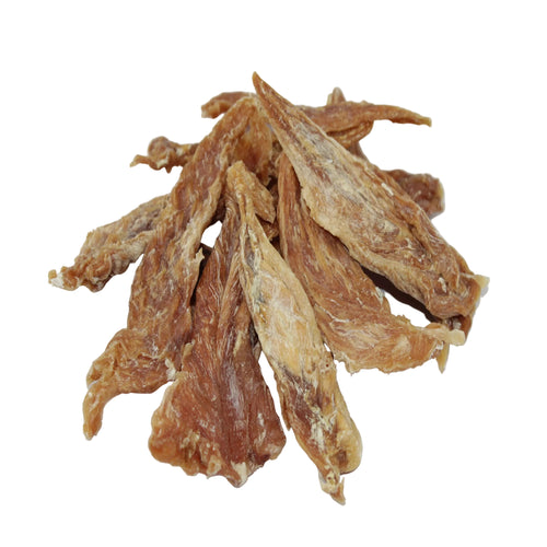 A pile of dried, chicken tenderloin dog treats with a textured, fibrous surface in shades of brown and tan, arranged on a plain white background.