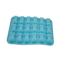 A light blue silicone mold tray with multiple bone-shaped cavities, photographed on a plain white surface.